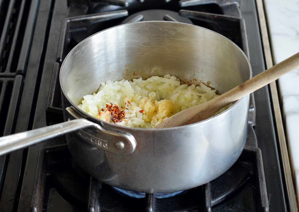 adding garlic and red pepper flakes