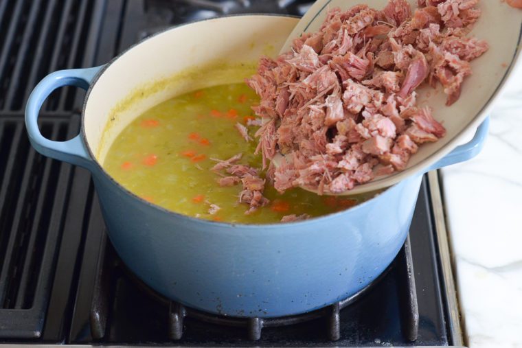 adding the shredded ham steak back to the soup.