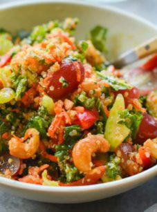 Bowl of autumn kale and quinoa salad with chutney dressing.