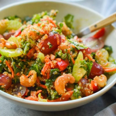 Bowl of autumn kale and quinoa salad with chutney dressing.
