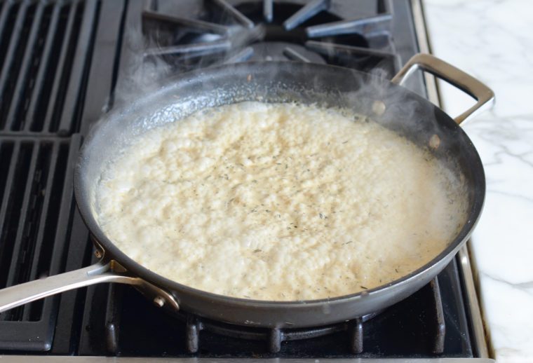 cream boiling and thickening in skillet