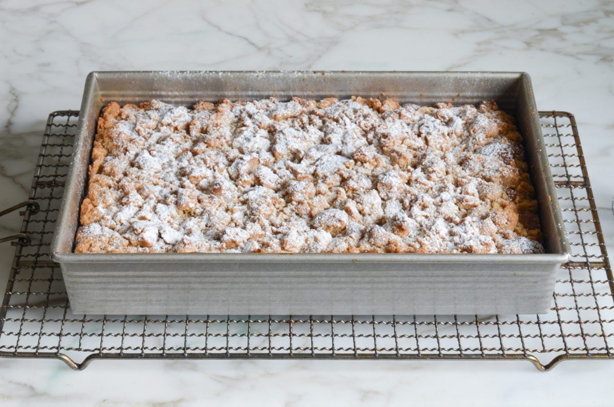 Crumb cake dusted with confectioners sugar.