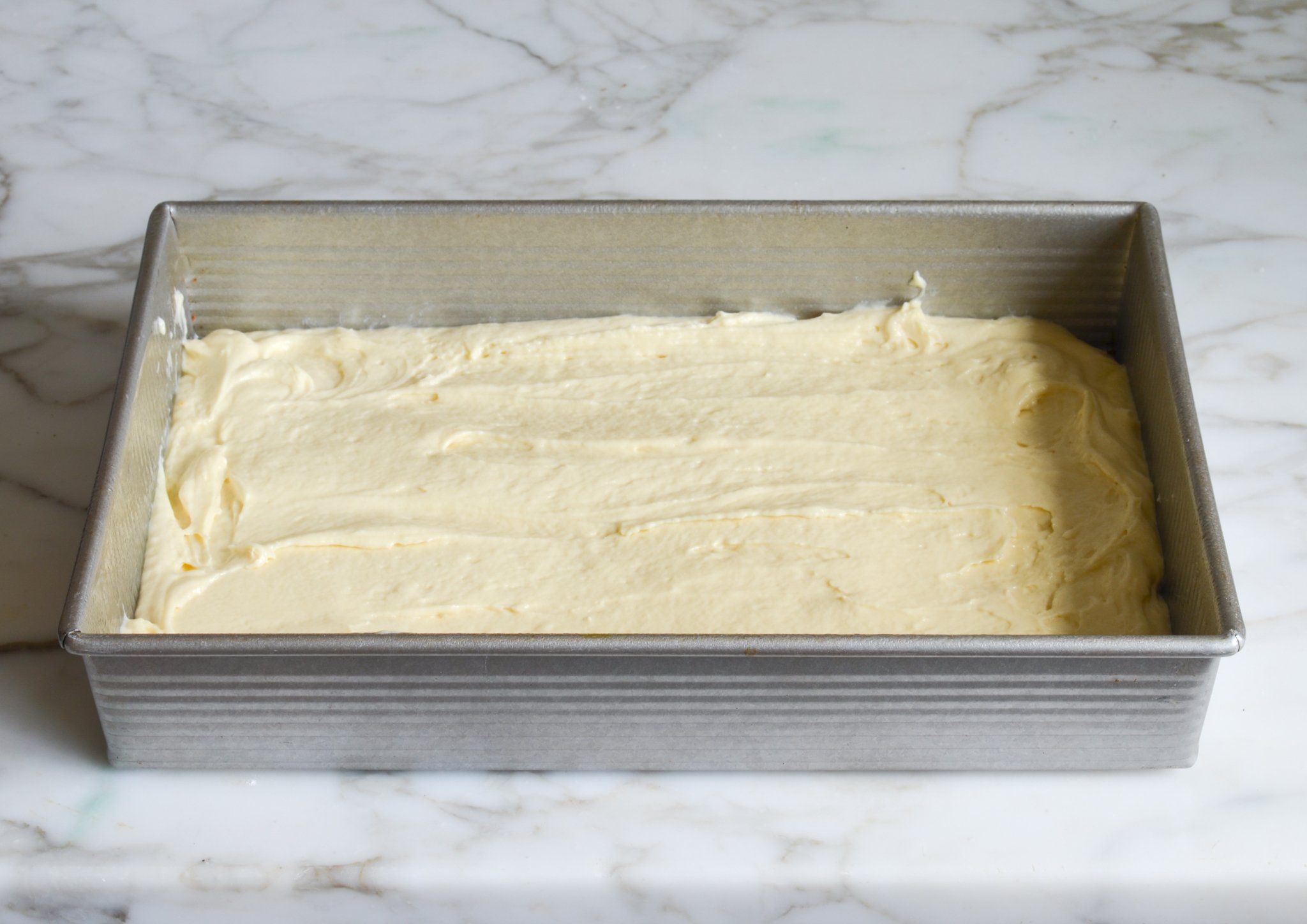 Spreading the batter in the cake pan.