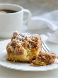 Piece of crumb cake on a plate.