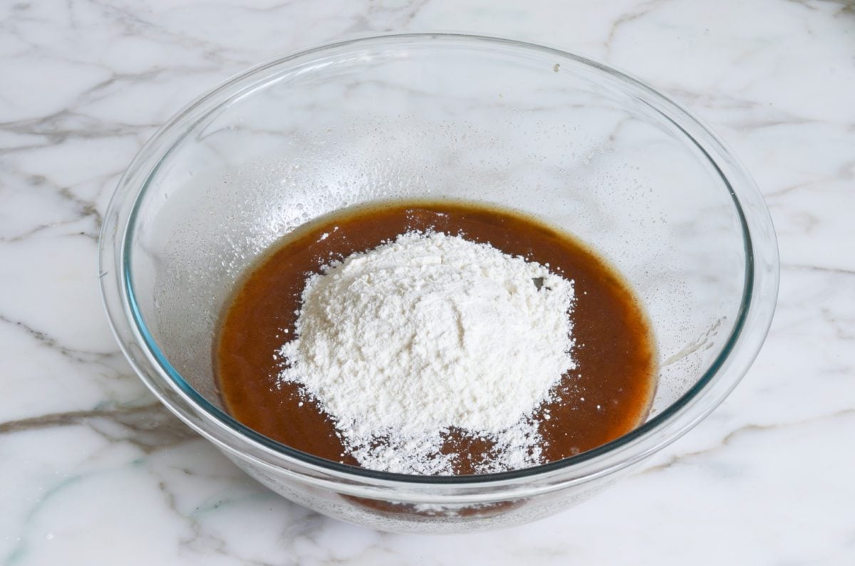 Gradually adding cake flour to mixture to make the crumb cake topping.