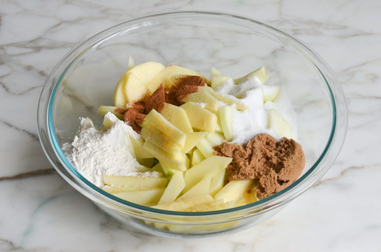 apples, sugars, flour, and cinnamon in bowl