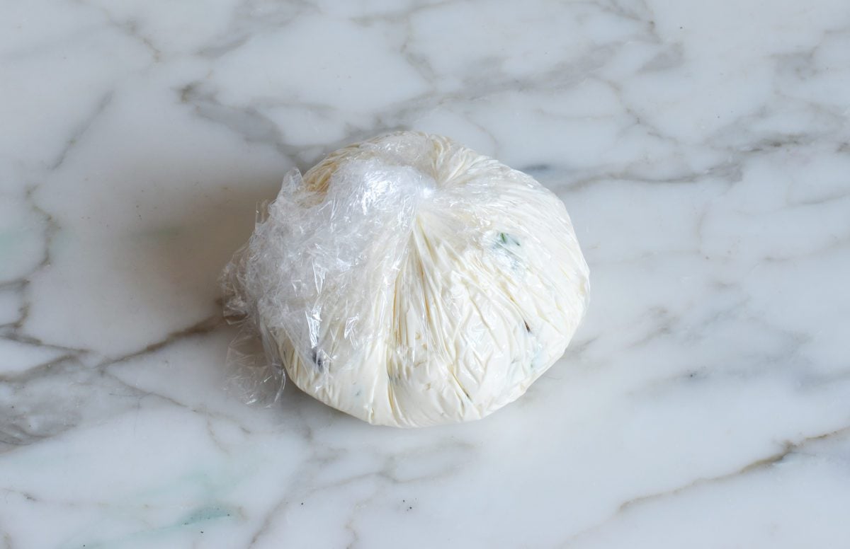 twisty plastic wrapped cheese ball ready to chill
