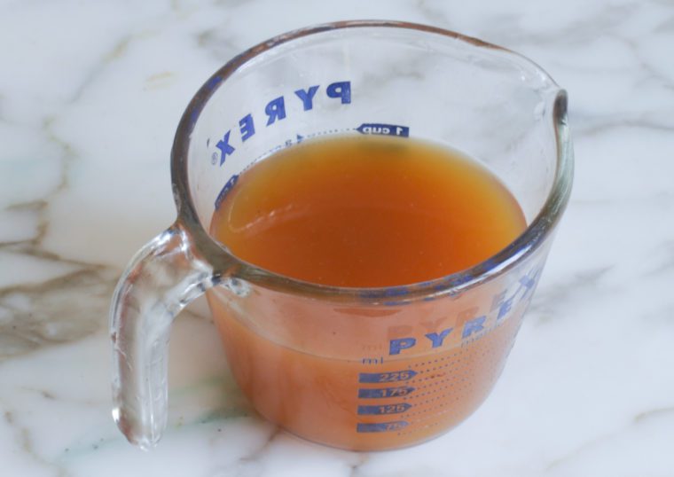 Apple cider mixture in a measuring cup.