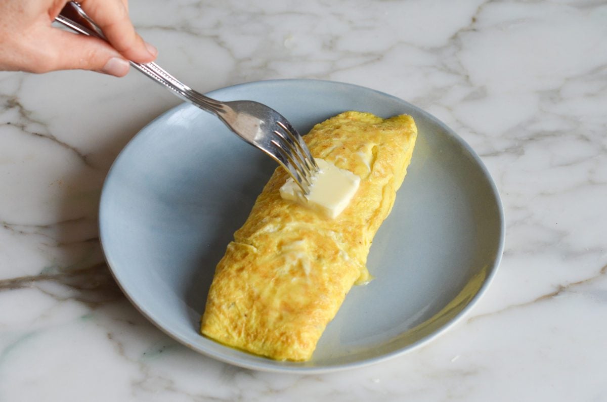 glossing the omelette with butter