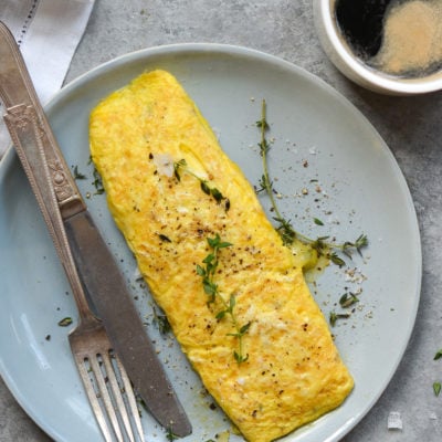 Omelet on a plate with silverware.