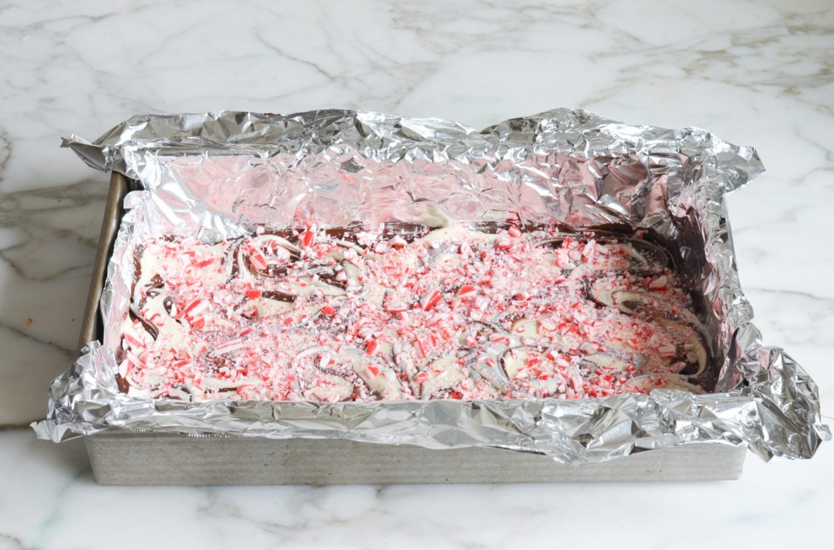 sprinkling the candy cane pieces over the swirled chocolates