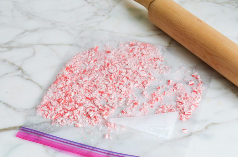 crushing the candy canes with a rolling pin