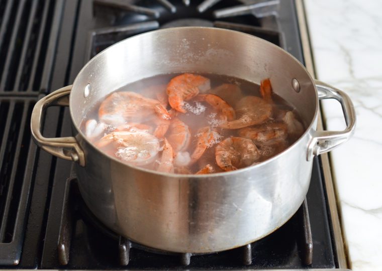 adding shrimp to boiling water