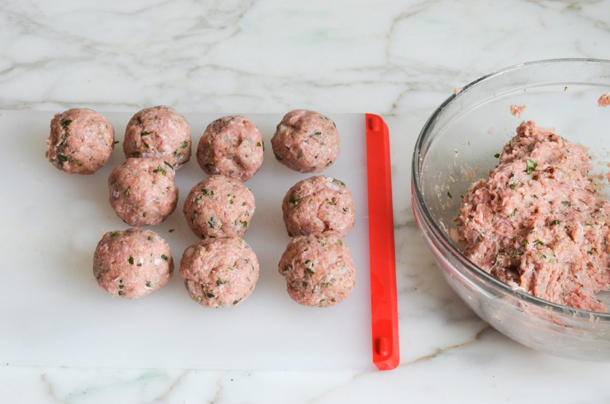 Formed meatballs on cutting board.