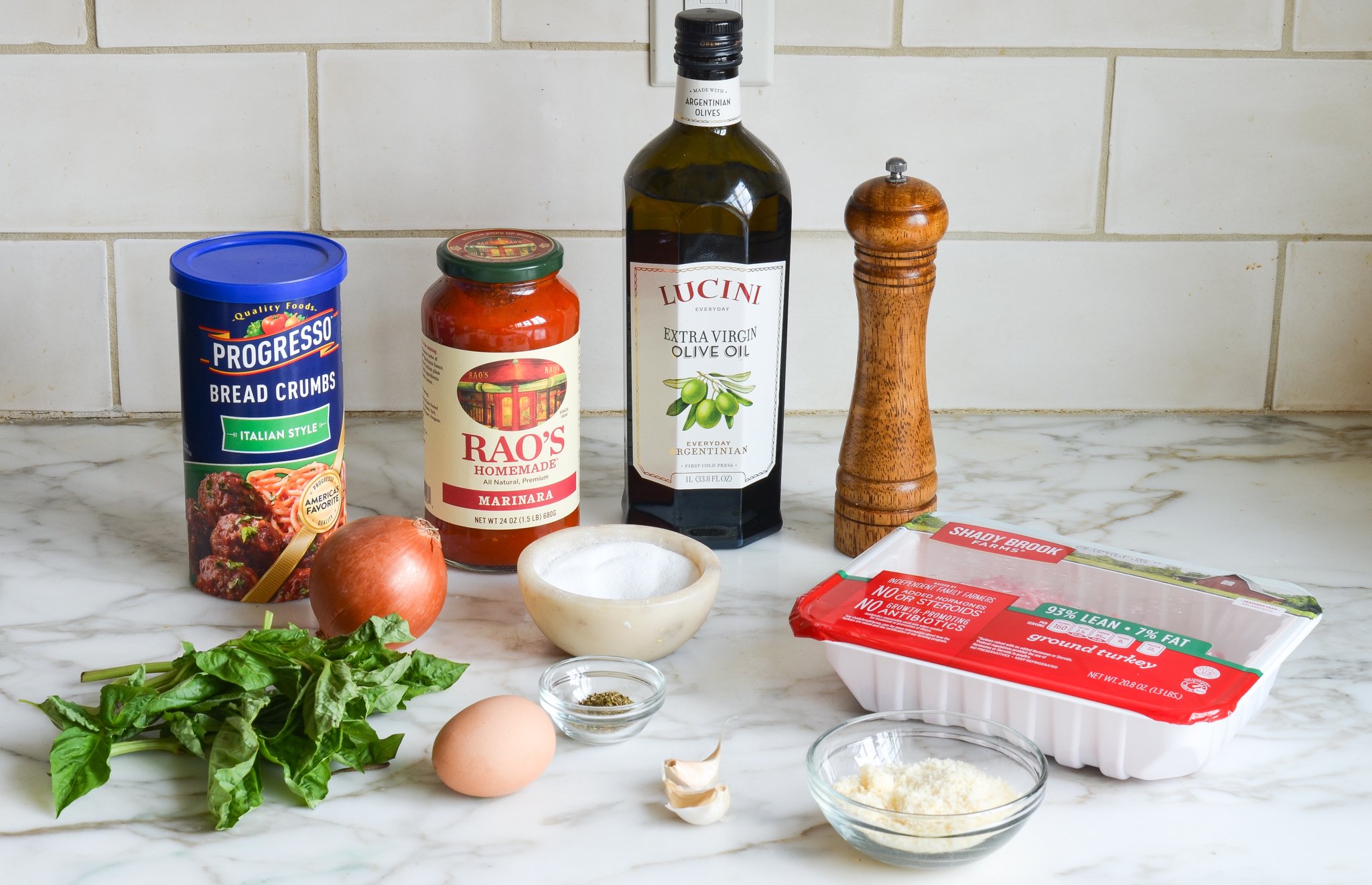 Turkey meatballs ingredients on a counter before mixing together.