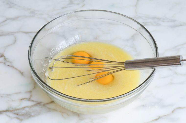 adding the eggs and egg yolks to the mixture