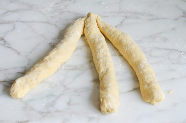 Three long strands of brioche dough.