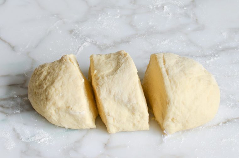 Three cut portions of brioche dough.