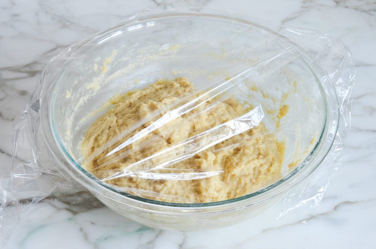 dough covered with plastic wrap