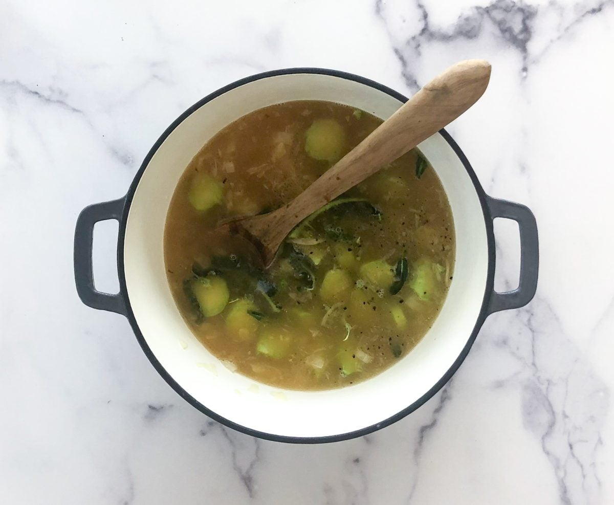adding broccoli stems, salt, pepper, broth and water