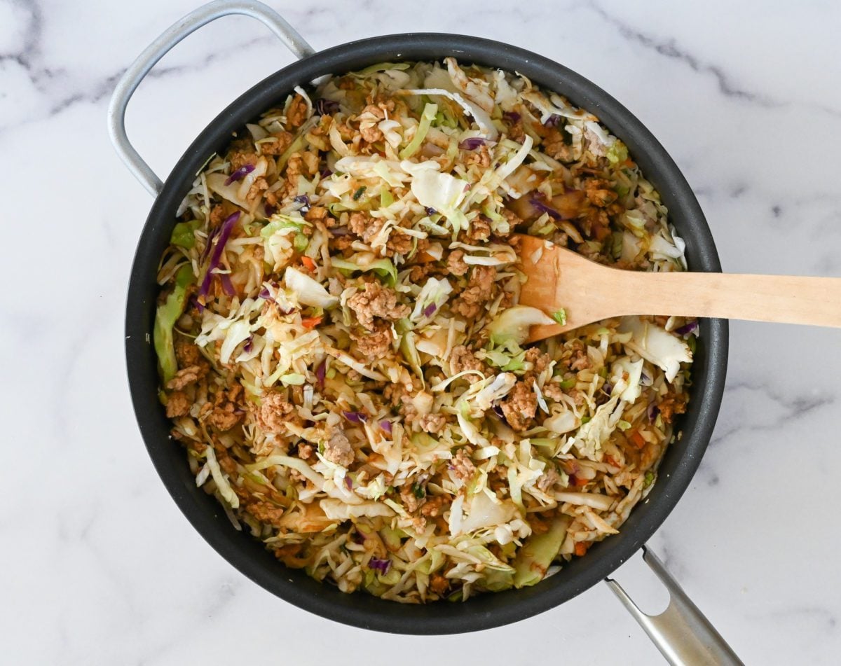 wilting coleslaw in skillet.