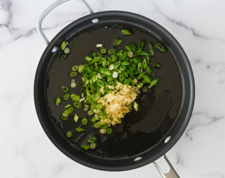 light scallions and ginger in skillet