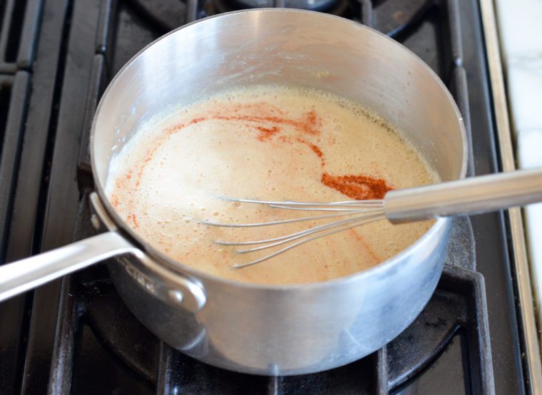 whisking in beer, half-and-half, and seasoning