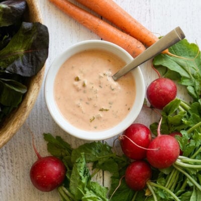 Russian dressing in a bowl near salad components
