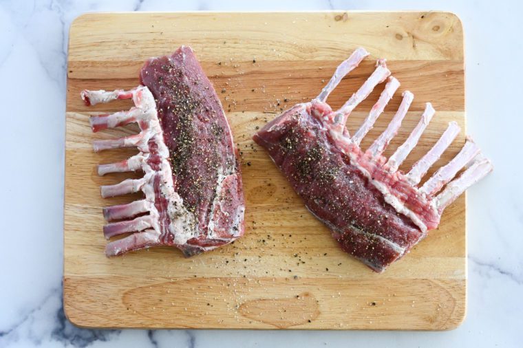 seasoning rack of lamb with salt and pepper