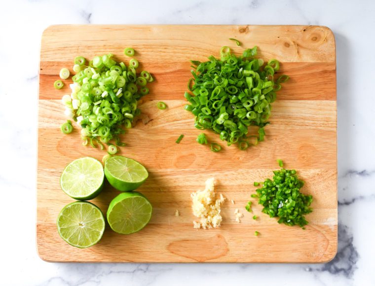 scallions, garlic, jalapeno, and lime prep for 7 layer dip 
