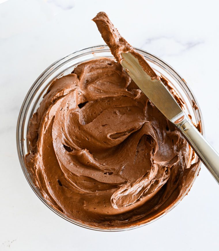 Knife on a bowl of rich chocolate buttercream.