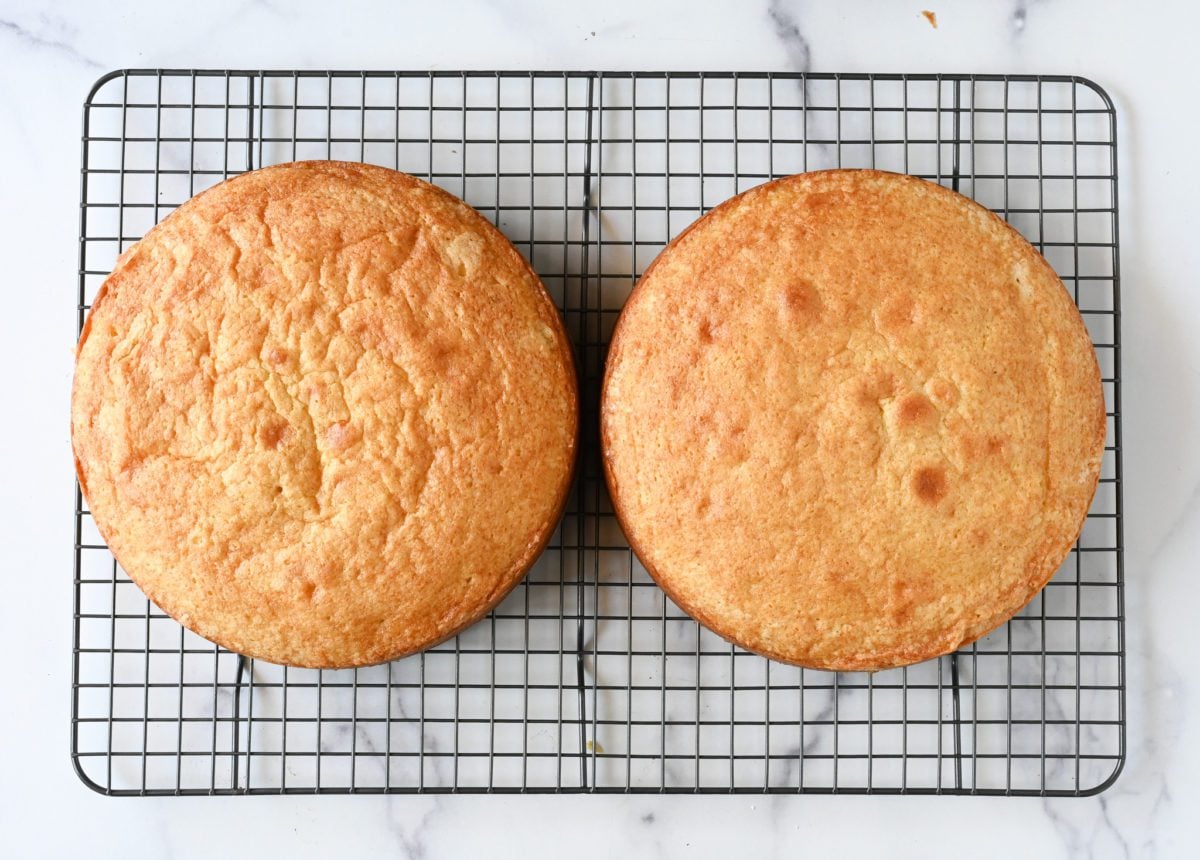 yellow cake layers cooling on baking rack