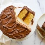 Partially-served yellow cake with rich chocolate buttercream.