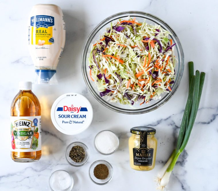 Coleslaw ingredients including sour cream, mayonnaise, and apple cider vinegar.
