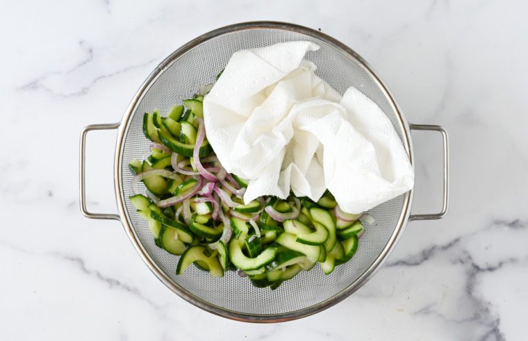 blotting cucumbers and onion dry with paper towel