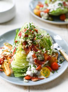 Wedge salad on a plate with a fork.