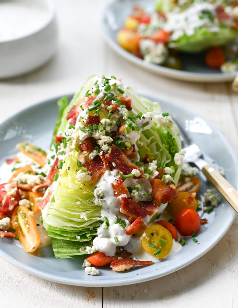 Wedge salad on a plate with a fork.