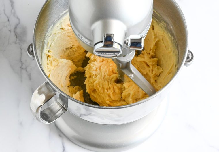 Moistened batter in a stand mixer.