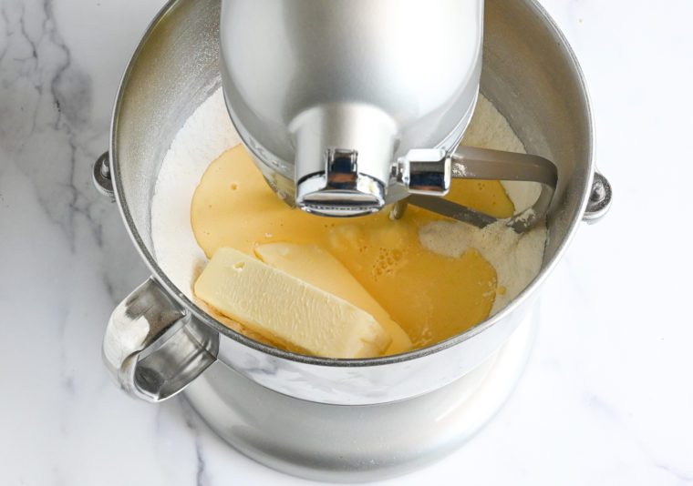 adding butter and half of buttermilk-egg mixture