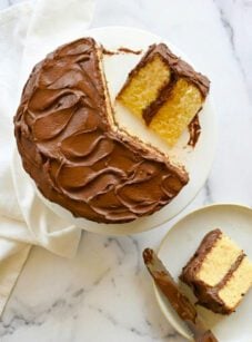 Sliced yellow cake on cake stand.