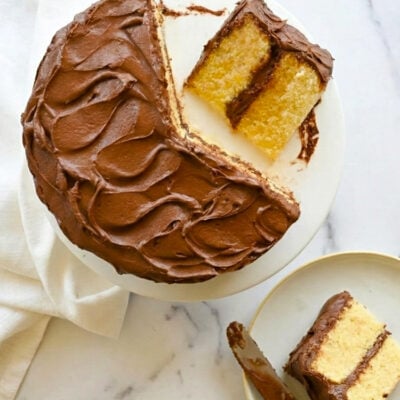 Sliced yellow cake on cake stand.