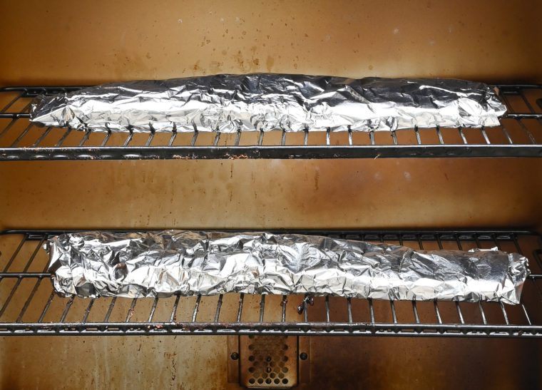 foil-wrapped ribs in the smoker