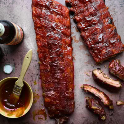 Bowl of barbeque sauce with baby back ribs.