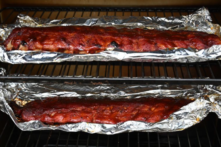 cooked racks of ribs in smoker 