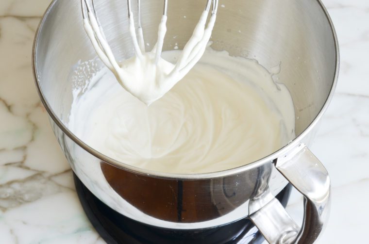 Whipped cream in a stand mixer.