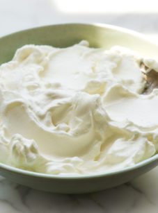 Spoon in a bowl of whipped cream.