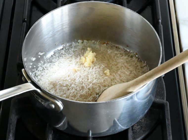 adding rice and garlic