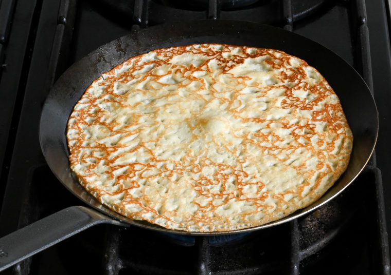 flipped crepe cooking on second side
