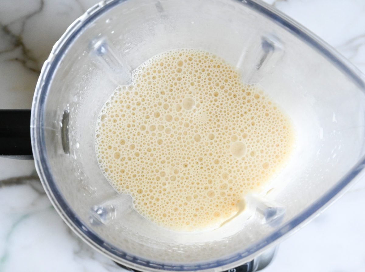 adding butter and blending crepe batter.