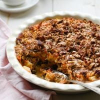 Spoon in a partially-served dish of baked oatmeal.